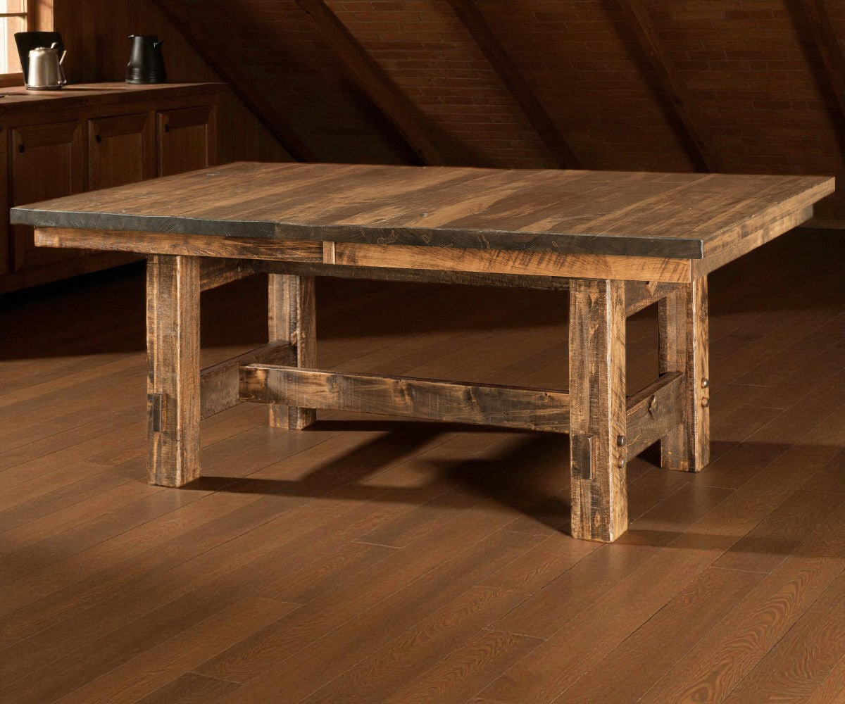 Wooden dining table with a rustic design on a wooden floor.