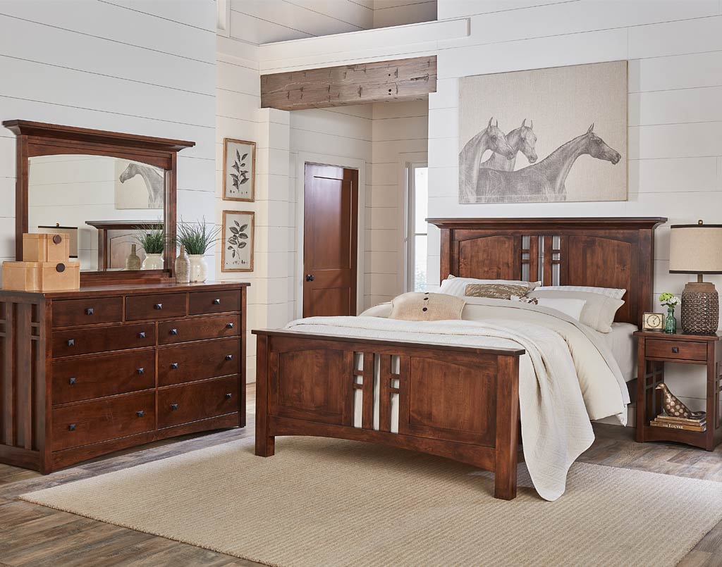 Wooden bedroom furniture set with bed, dresser, and mirror in a room.