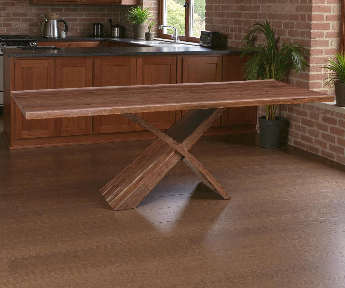 Wooden dining table with X-shaped legs in a kitchen setting