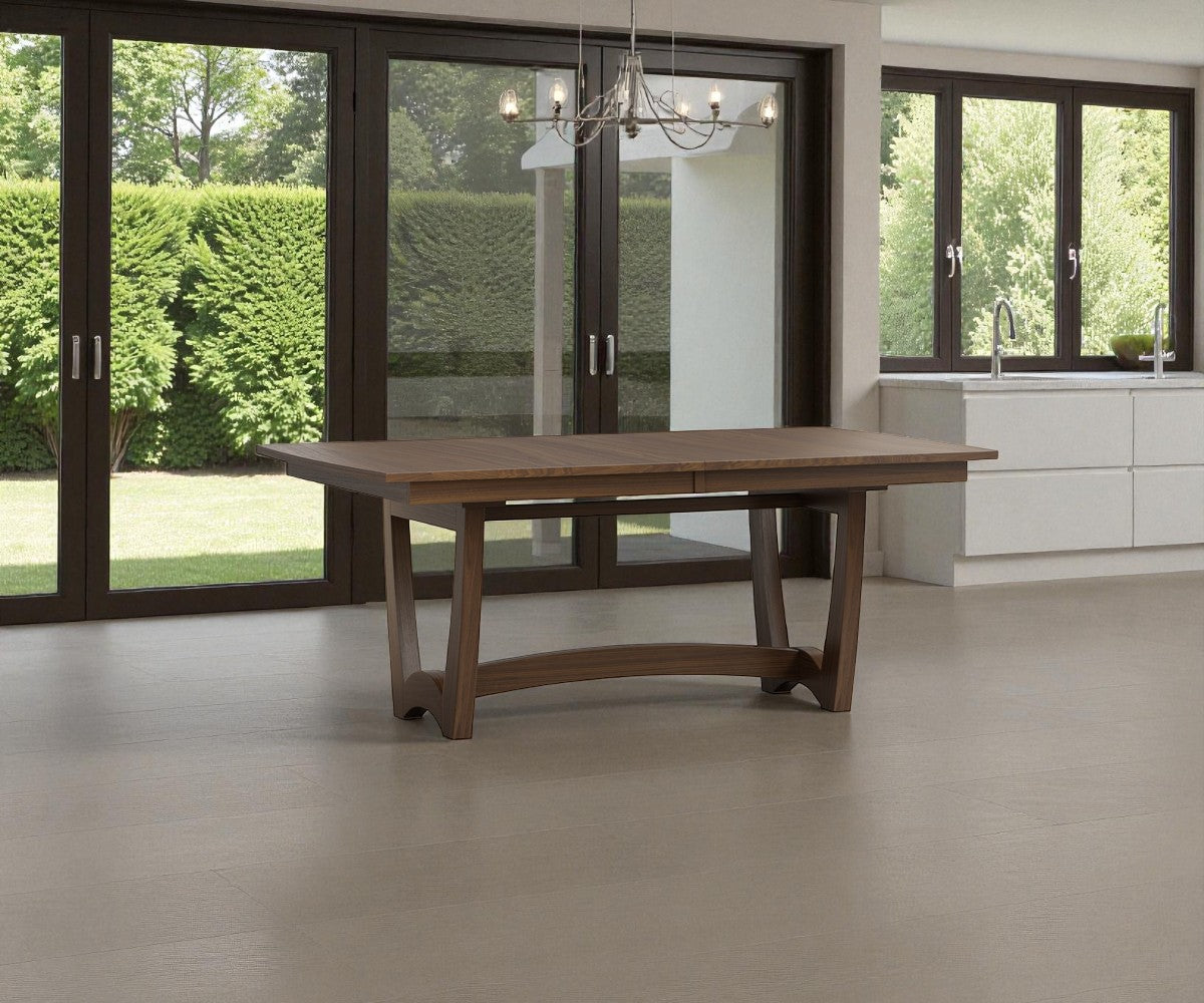 Wooden dining table in a modern kitchen with large windows