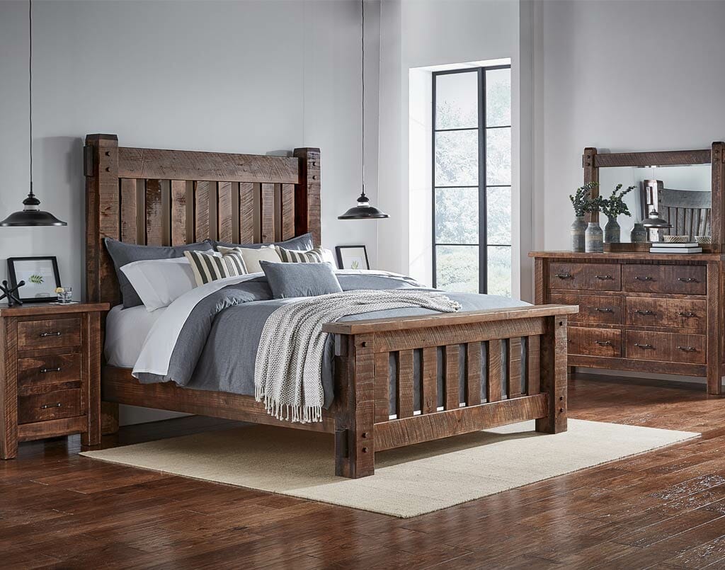 Wooden bedroom set with bed, nightstands, and dresser in a room with large windows.