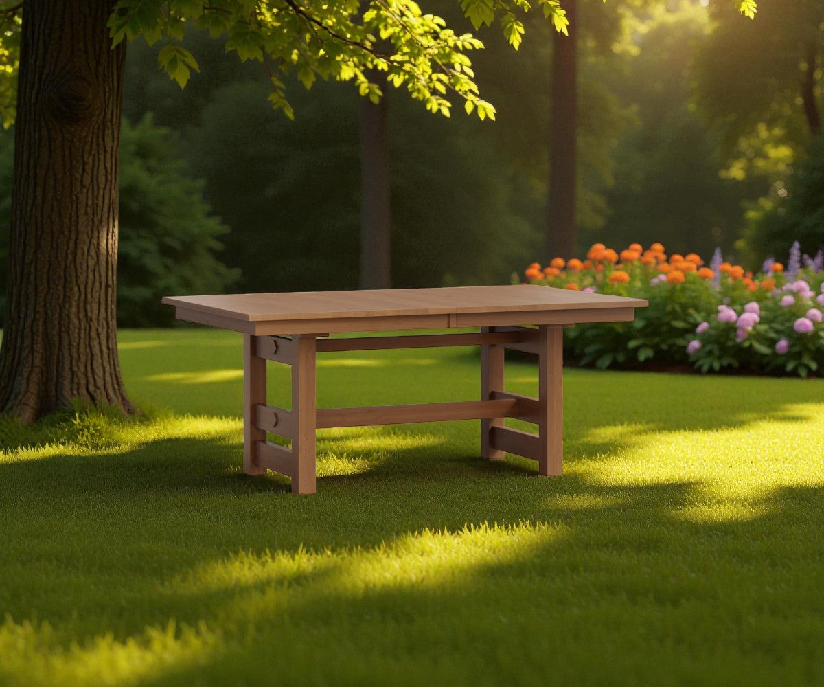 Wooden table in a garden setting with trees and flowers