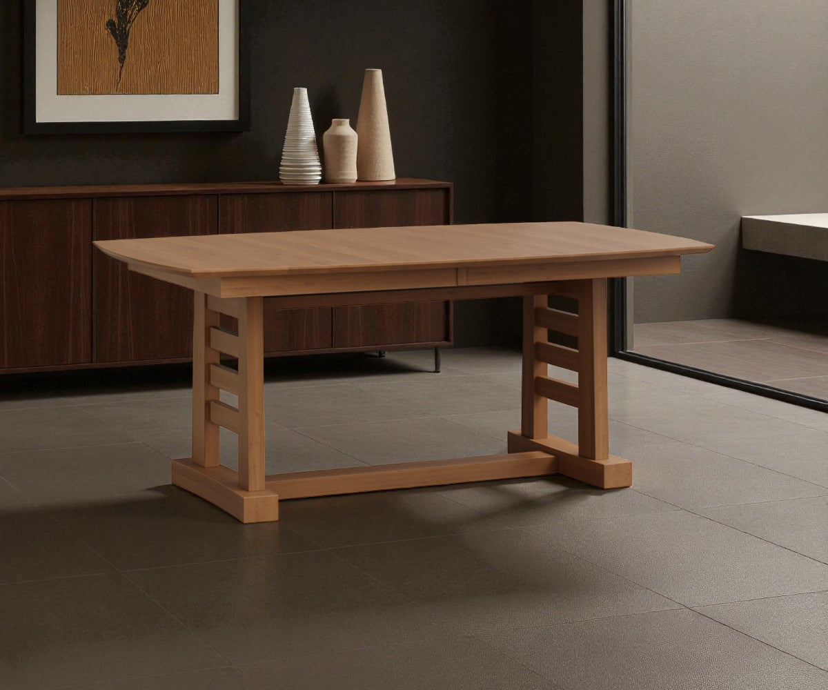 Wooden dining table in a room with a dark wall and framed picture.