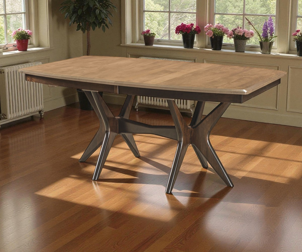 Wooden dining table in a room with windows and potted plants.