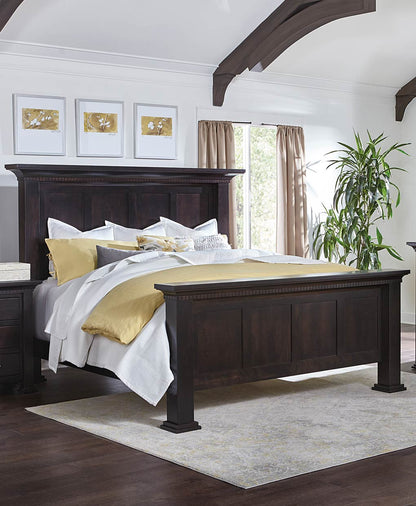 Bedroom with a dark wood bed frame, white bedding, and gold accents.