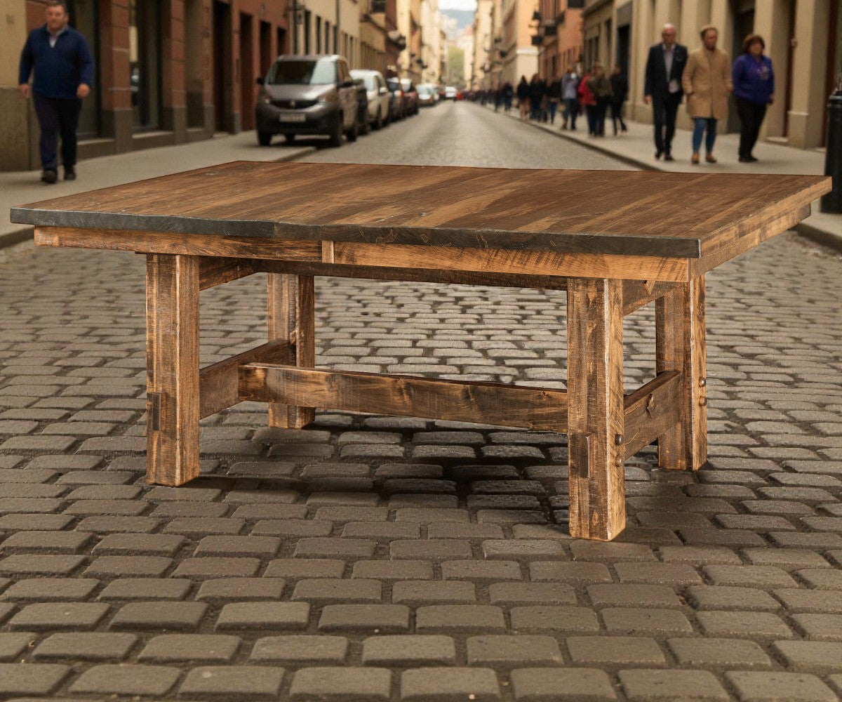Wooden table on a cobblestone street with people and vehicles in the background