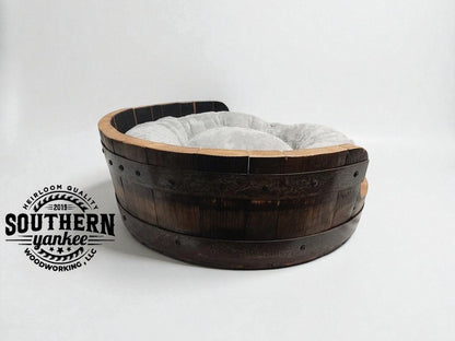 Wooden pet bed with gray cushion on a white background, featuring Southern Yankee Woodworking logo.