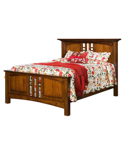Wooden bed with floral bedding and a red throw on a white background