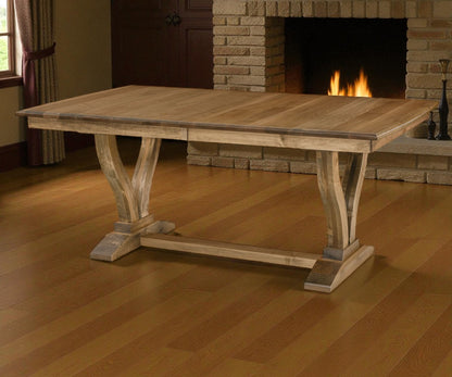 Wooden dining table in a room with a fireplace