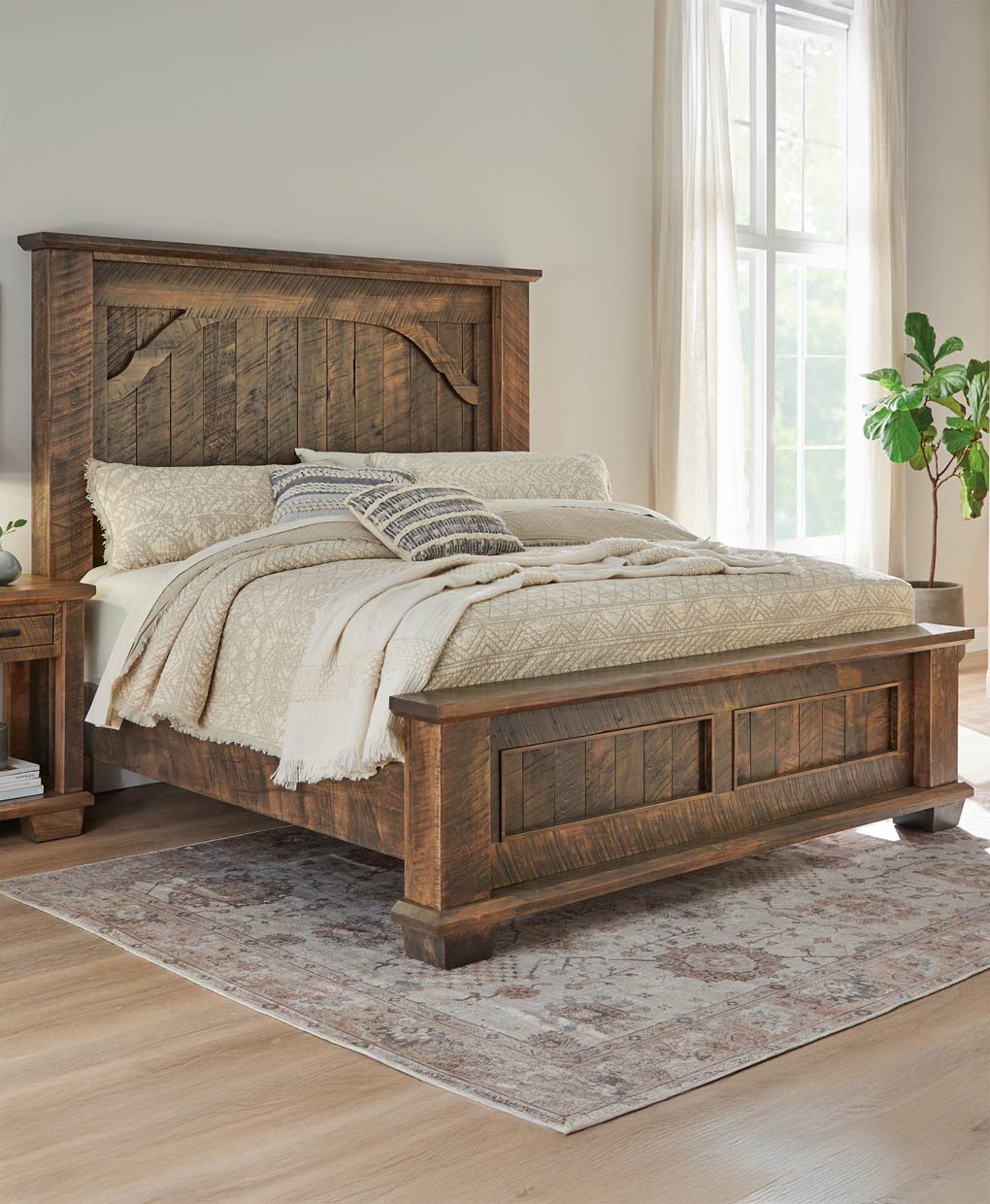 Wooden bed in a bedroom with a rug and window