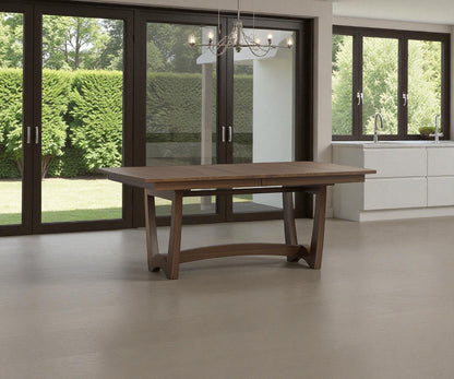 Wooden dining table in a modern kitchen with large windows