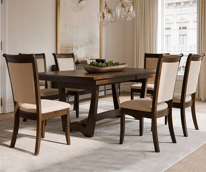 Dining room with wooden table and chairs in a well-lit room.