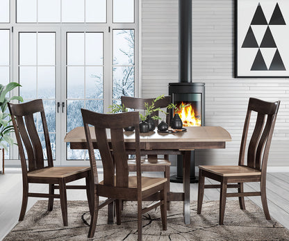 Dining room with wooden table and chairs in front of a fireplace.