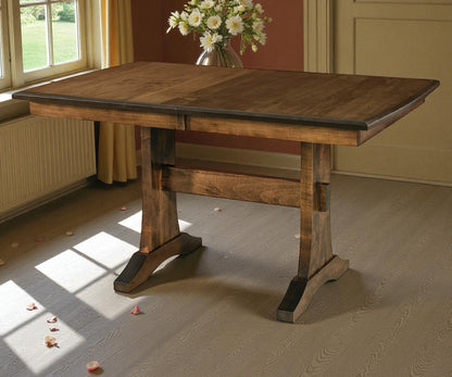 Wooden dining table with a vase of flowers in a room with a window and radiator.