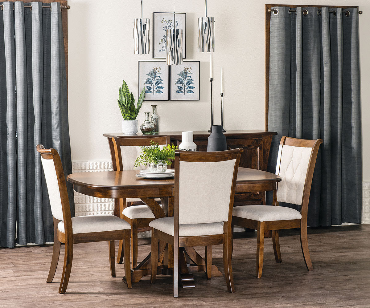 Dining room with wooden table and chairs, curtains, and wall art.